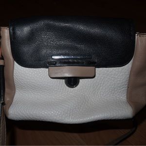 Marc Jacob’s white, beige, and black crossbody bag.